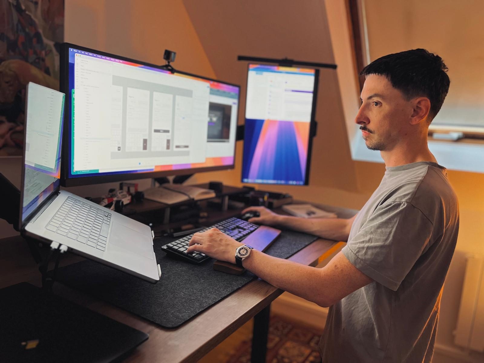 Guillaume David at his desk, wireframes on screen